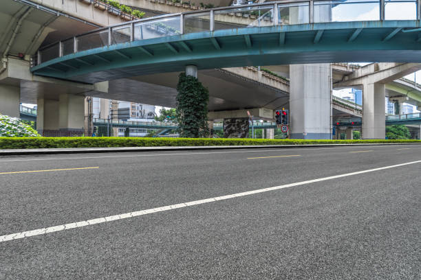 istock empty asphalt road with city overpass viaduct bridge in shanghai 1012398430