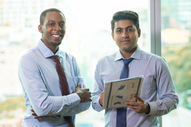 istock Happy multi-ethnic business team with financial report 1012405468
