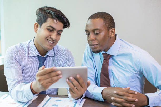 istock Cheerful business colleagues testing new app 1012405690