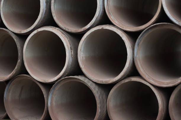 istock Concrete tubes on cracked muddy ground 1012408344