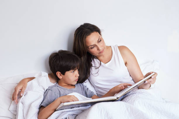 istock Mother reading to boy 1012411728