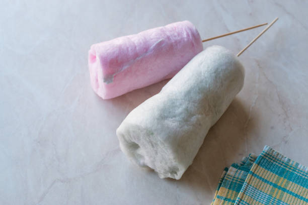 istock Cylinder Shape Cotton Candy with Wooden Stick on Marble Surface. 1012429930