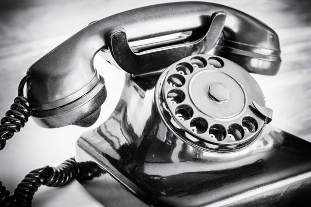istock Very old telephone as a retro object in a black and white shot 1012436474