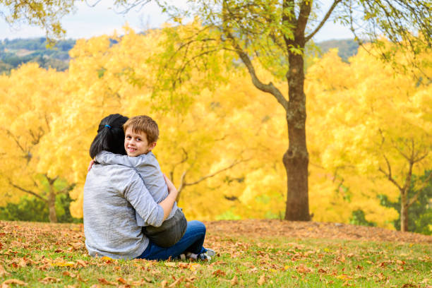 istock Mother and son in autumn park 1012439918