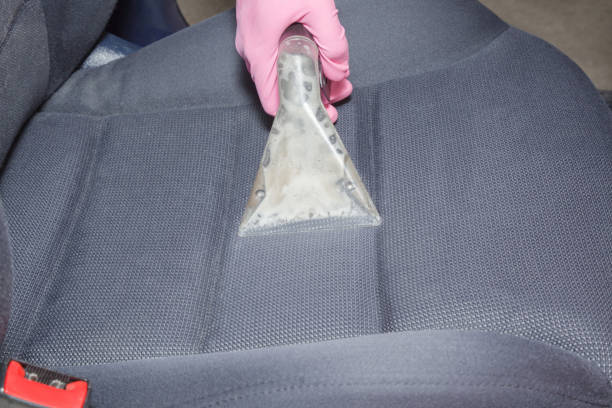 istock Employee hand cleaning dirty driver's seat with professionally extraction method. Early spring regular cleanup. Care about auto interior. Commercial cleaning company concept. 1012439988