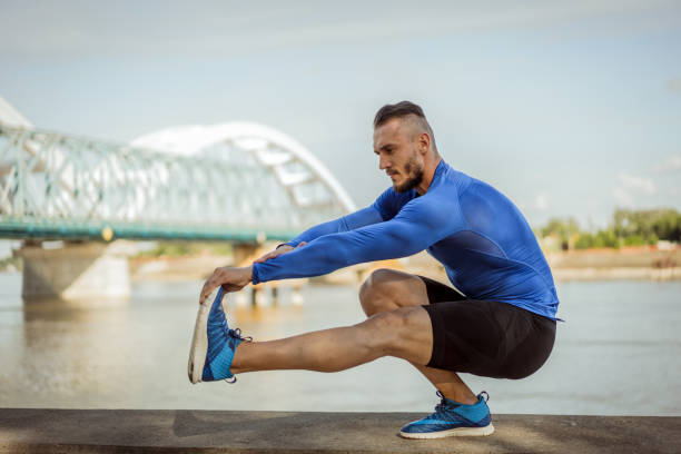 istock Young handsome tattooed man training hard outdoors 1012440168