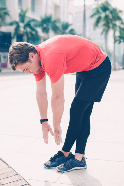 istock Sporty Man Bending and Stretching Outdoors 1012445092
