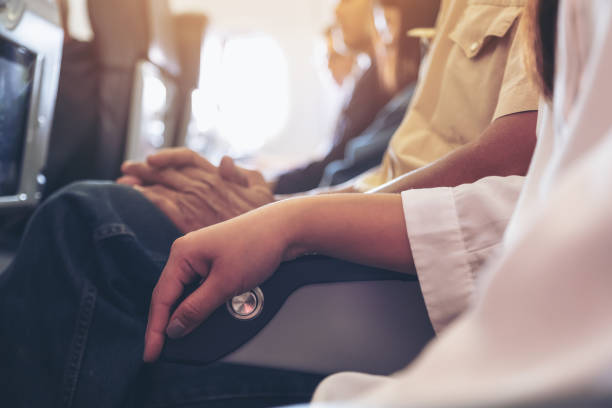 passenger sitting on a seat row in cabin - airplane seat imagens e fotografias de stock