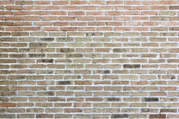 istock Weather stained old brick wall background 1012455052