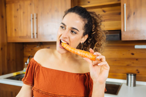 istock Beautiful Woman with a Carrot 1012455520