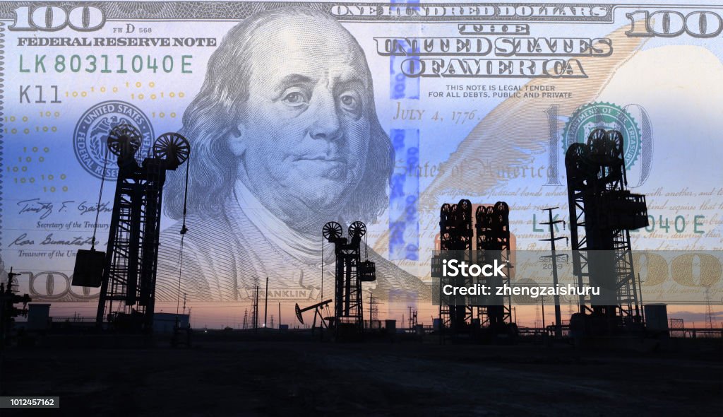 Dollars and oil pumps Petroleum, petrodollar and crude oil concept, Oil pump on background of US dollar, Dollars and oil pumps Business Stock Photo