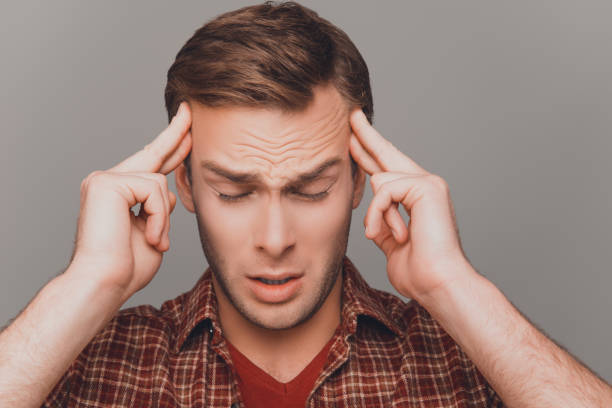 istock Young sad businessman with big problems touching his head 1012466264