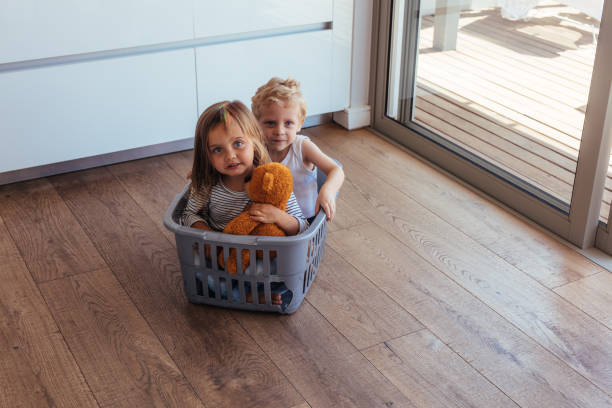 istock Children sitting in a washing basket 1012466904