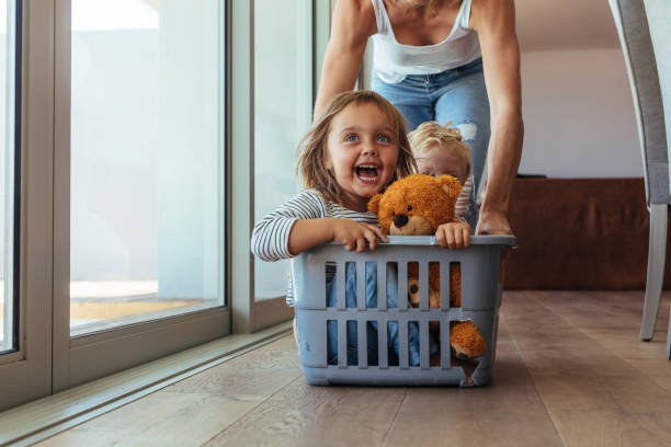 istock Cute family playing together at home 1012466964