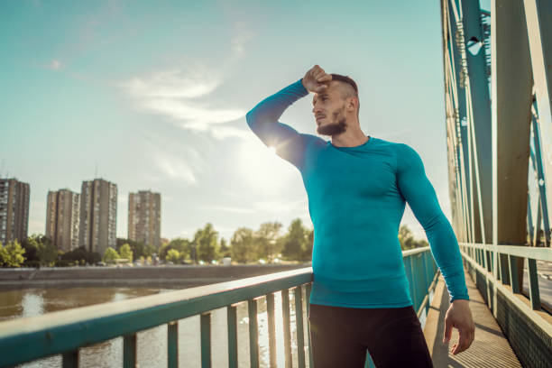 istock Young handsome tattooed man resting after training hard outdoors 1012470228
