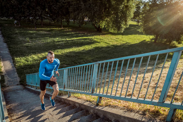 istock Young handsome tattooed man running training hard outdoors 1012470696
