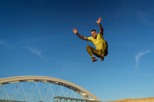 istock Young handsome tattooed man jumping and training hard outdoors 1012475700