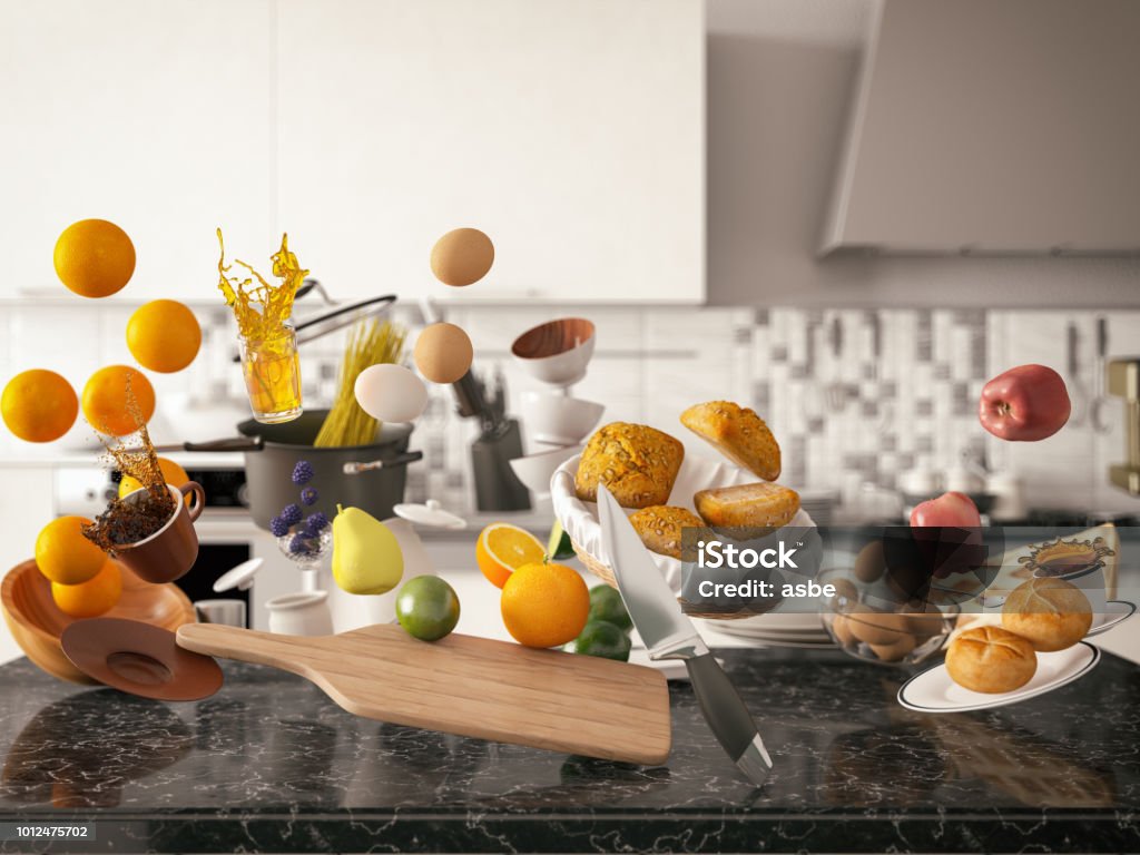 Zero Gravity in Kitchen. Levitation Zero gravity concept with kitchen utensil and food Kitchen Counter Stock Photo