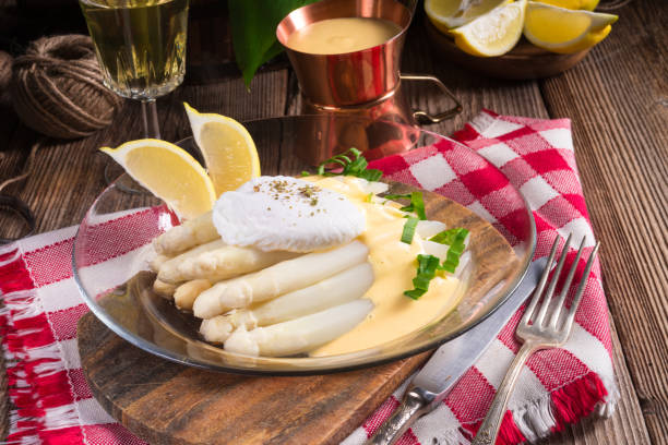 istock white asparagus served with a fine hollandaise sauce and Poached egg 1012488116