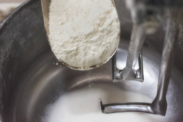istock Loading flour into an industrial dough mixer. Close up view. 1012496882
