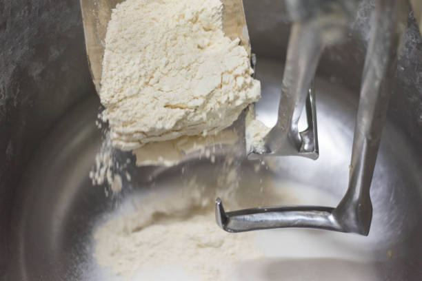 istock Loading flour into an industrial dough mixer. Close up view. 1012496924