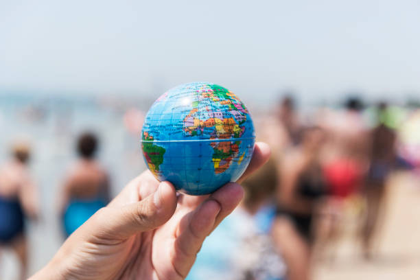 young man with a world globe in his hand