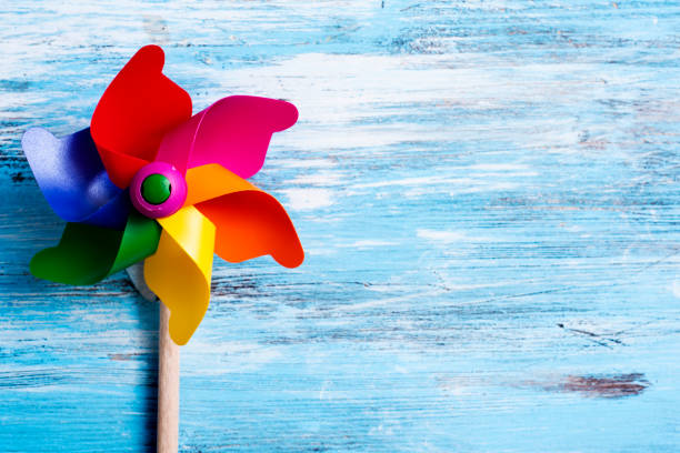 istock colorful pinwheel on a blue wooden surface 1012497570