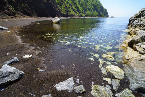 Rocky seashore on a sunny day. Sakhalin Island, Russia.