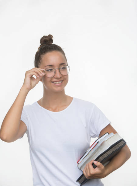 istock Young happy student holding books. Education concept. Back to school. Isolated on white background 1012506488