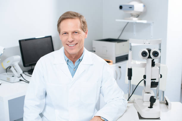 istock handsome smiling ophthalmologist looking at camera in consulting room 1012507094