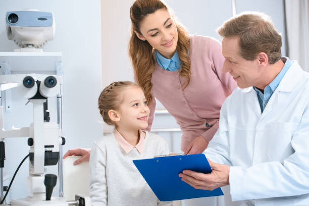 istock smiling ophthalmologist showing something to patient in clipboard 1012507112