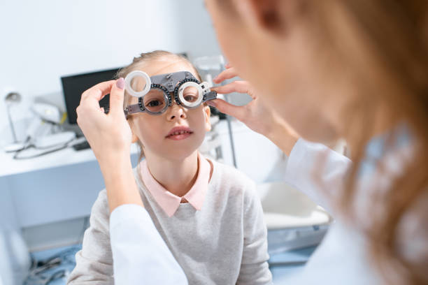 istock selective focus of ophthalmologist examining kid eyes with trial frame in clinic 1012509814