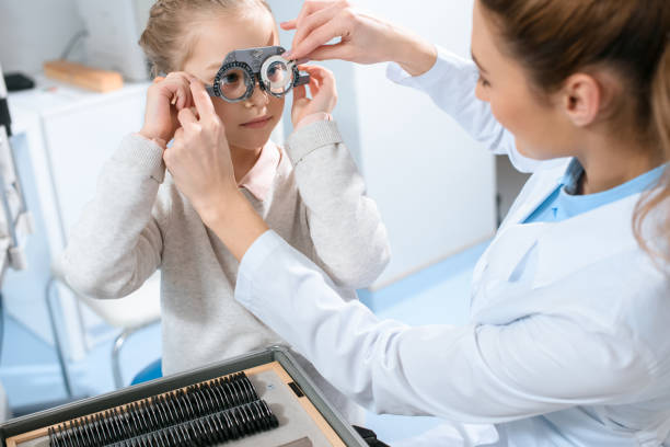 istock female ophthalmologist examining kid eyes with trial frame and lenses 1012509850