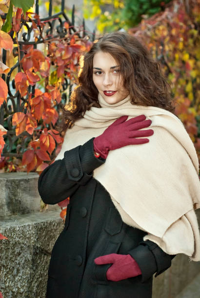 istock woman in a  coat walks in autumn park 1012510678