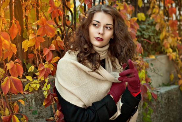 istock woman in a  coat walks in autumn park 1012510706