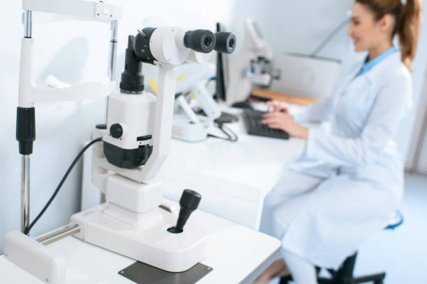 istock selective focus of optometrist working with computer in clinic, visual field test on foreground 1012510798