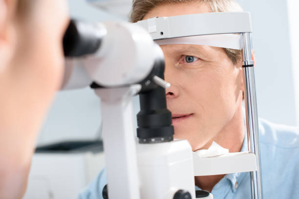 istock optometrist examining man with modern optical equipment 1012512862