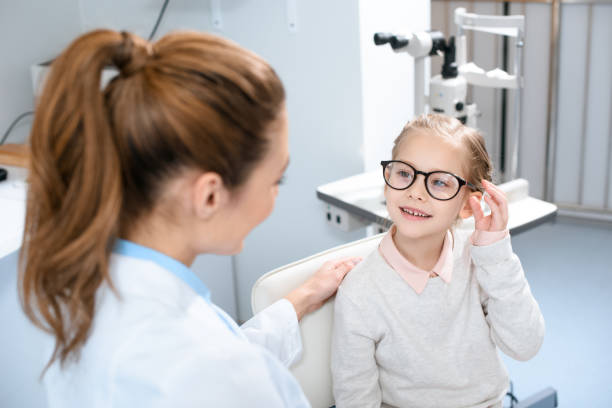 istock ophthalmologist and smiling kid in eyeglasses in optics 1012513138