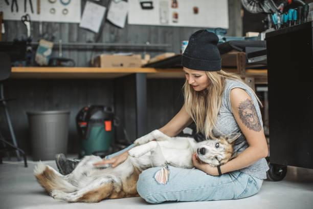 istock Women in workshop with her pet dog 1012513724