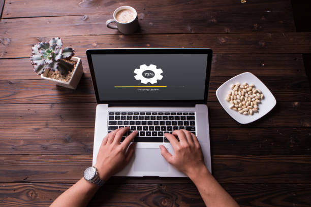 istock Top view of installing update process with gearbox percentage progress and loading bar on laptop / computer 1012514222