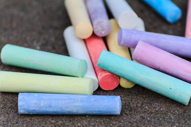 istock colorful crayons are scattered on the pavement 1012519126