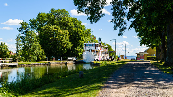 Berg, Sweden - June 30, 2018: The vintage passenger boat Diana traveling the Gota canal on a fine summer day. Here entering the marina area after a climb through several sluice gates.