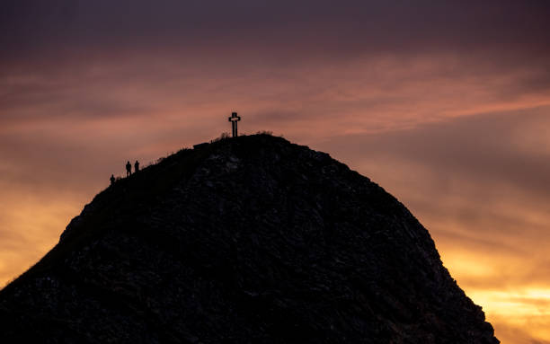 istock mountain peak with cross and people during sunset silhouette dramatic sunset brienzer rothorn switzerland 1012522300