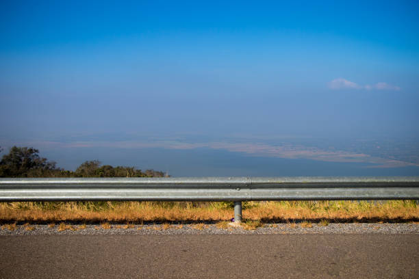 Ocean side highway and gard rail, Behide is beautiful mountain view and blue sky. Road side view mountain and sea background.Side road with mountain and blue sky view