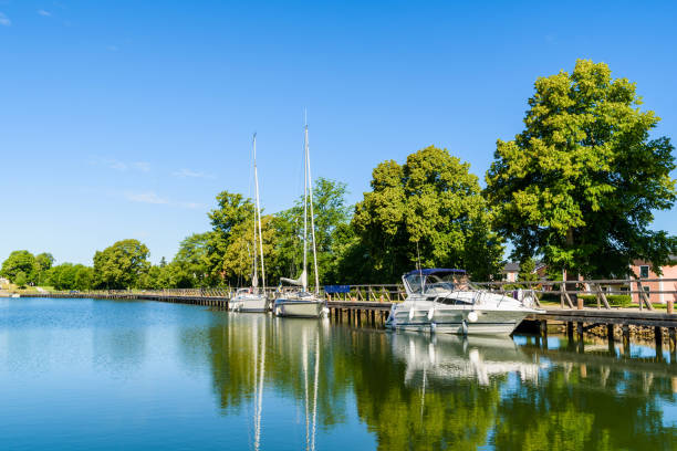 istock Boats moored at long promenade 1012522442
