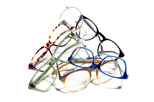 Studio shot of heap of glasses isolated on white background.