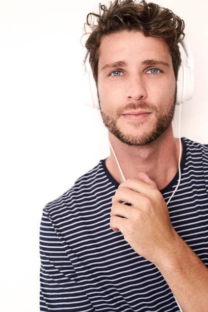istock Blue eyed boy with phones 1012522894