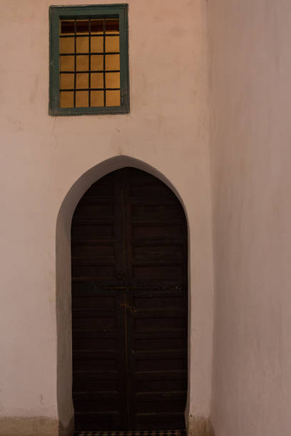 istock old door with window and white wall 1012523248