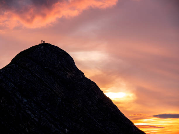 istock people on mountain summit peak with cross during sunset silhouette dramatic sunset brienzer rothorn switzerland 1012523316