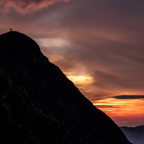 istock people on mountain summit peak with cross during sunset silhouette dramatic sunset brienzer rothorn switzerland 1012523390